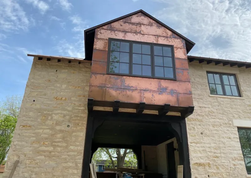 Copper metal panel facade on a stone building for Roof Repair in Tisbury